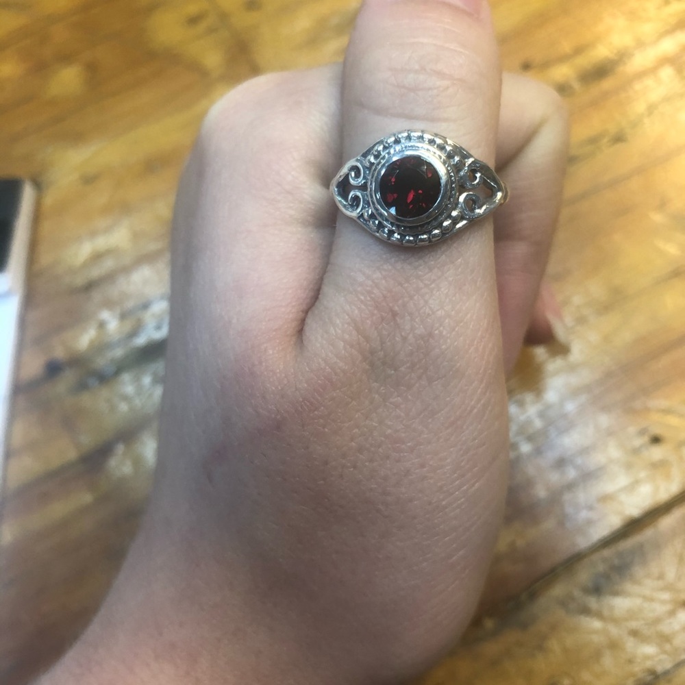 Detailed silver and deep red garnet ring